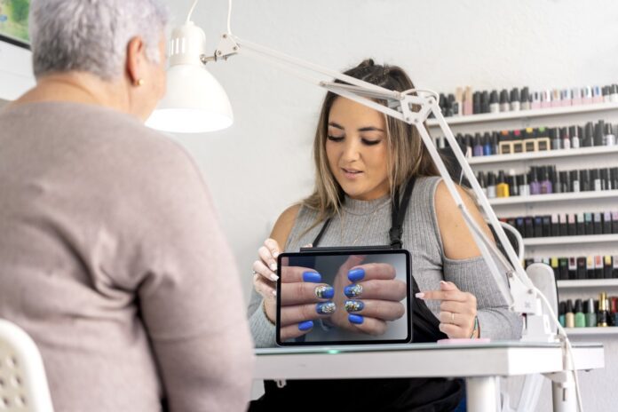 real-female-manicurist-showing-a-nail-painting-des-2025-01-09-21-56-02-utc